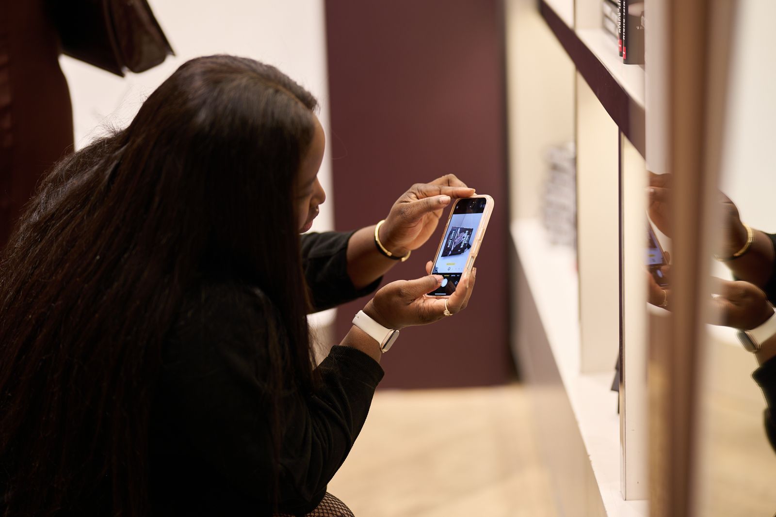 A guest photographing a client book on display at a Brandspire launch